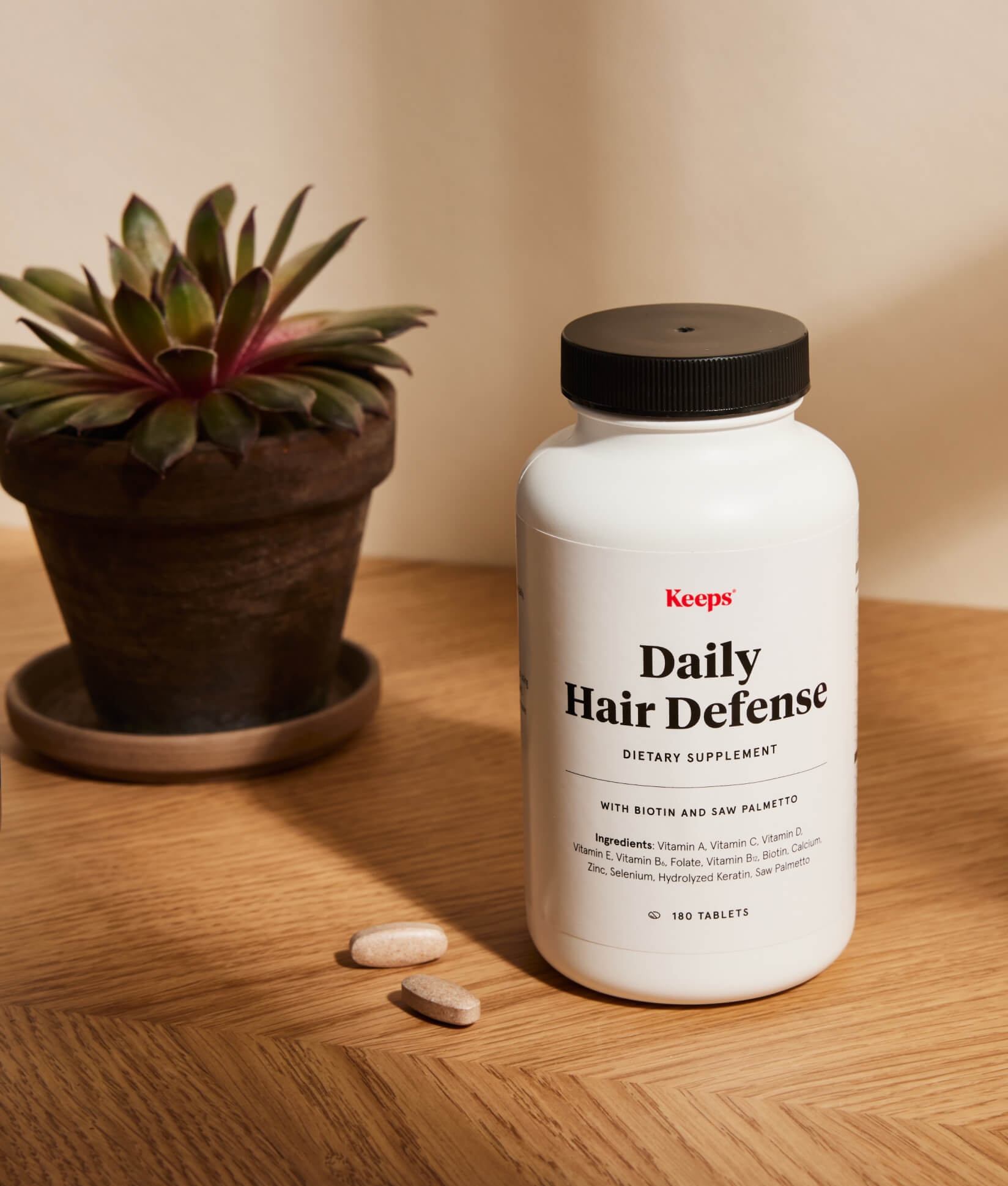 A bottle of Daily Hair Defense Supplement