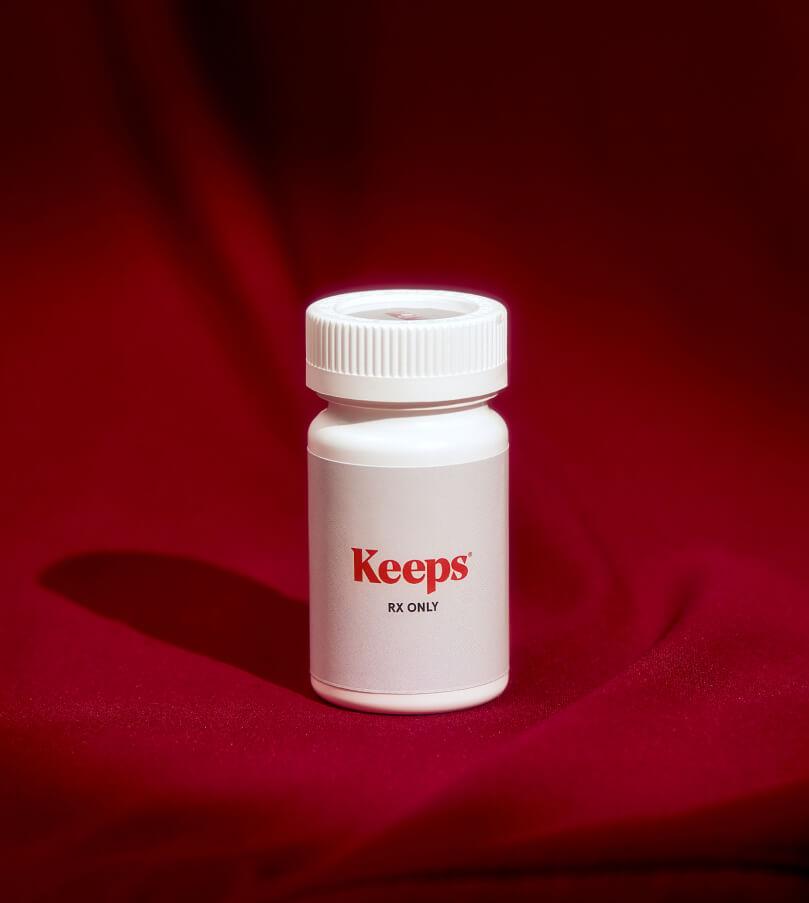 prescription bottle with red curtain in background