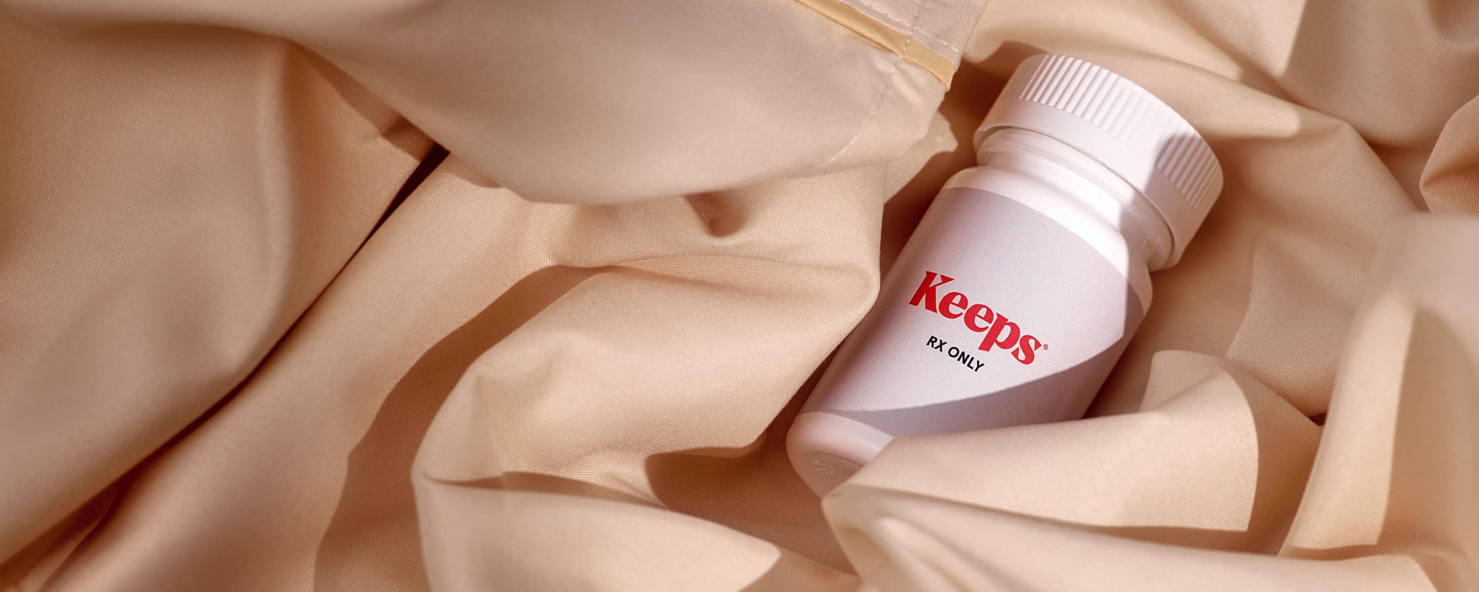 Pill bottle laying in bed sheets